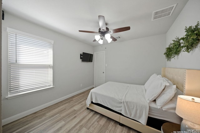 bedroom with ceiling fan and light wood-type flooring