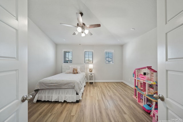 bedroom with ceiling fan and light hardwood / wood-style flooring