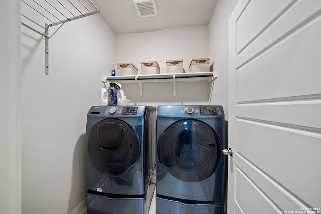 clothes washing area with separate washer and dryer