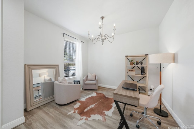 home office featuring a chandelier and light hardwood / wood-style flooring