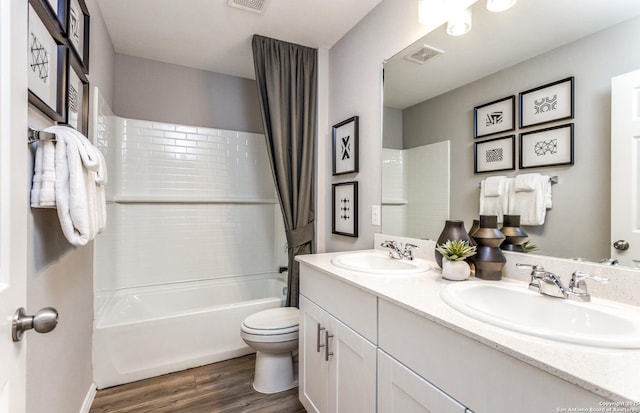 full bathroom with toilet, vanity, shower / bath combo, and hardwood / wood-style flooring