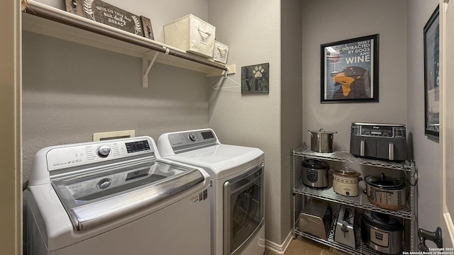 clothes washing area with separate washer and dryer