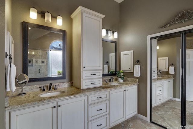 bathroom with vanity and a shower with door