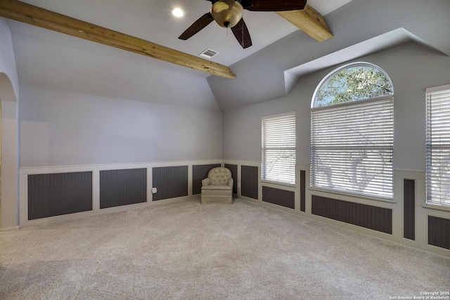 interior space with ceiling fan and lofted ceiling with beams