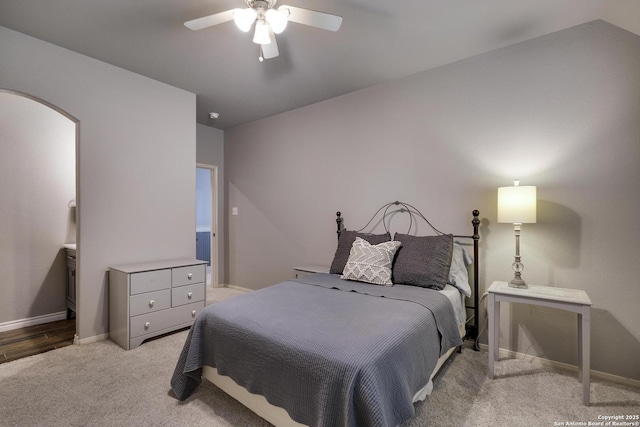 bedroom with lofted ceiling, light colored carpet, and ceiling fan