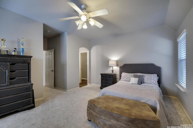 bedroom featuring lofted ceiling, light colored carpet, and ceiling fan