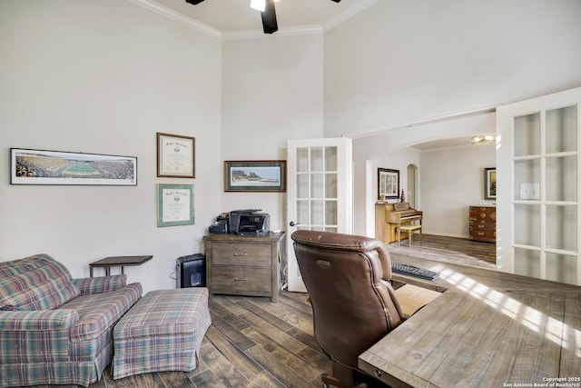 office space with crown molding, dark wood-type flooring, ceiling fan, a high ceiling, and french doors