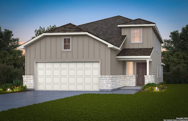 view of front of home featuring a garage and a lawn