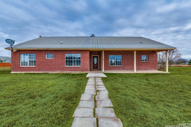 rear view of property with a patio area and a lawn