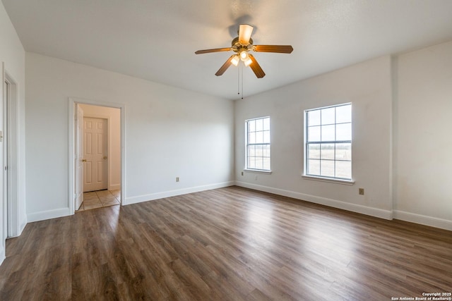 empty room featuring ceiling fan and dark hardwood / wood-style floors