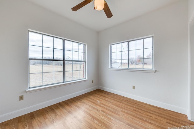 empty room featuring light wood-type flooring and ceiling fan