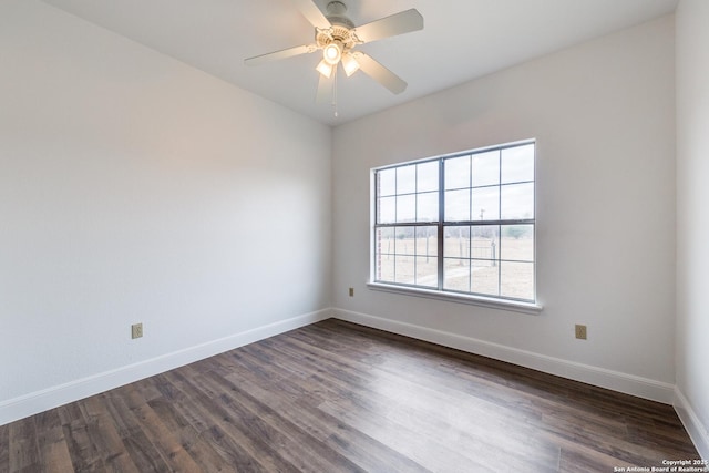 empty room featuring ceiling fan and dark hardwood / wood-style floors