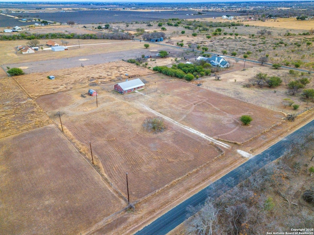 birds eye view of property with a rural view