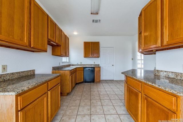 kitchen with light tile patterned floors, black dishwasher, sink, and dark stone counters