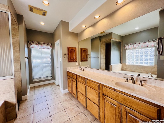 bathroom featuring a tub, tile patterned floors, and vanity