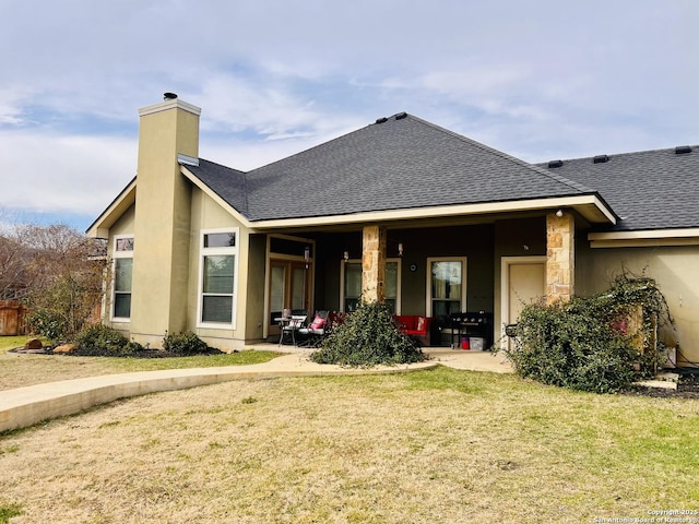 back of property with a patio area and a yard