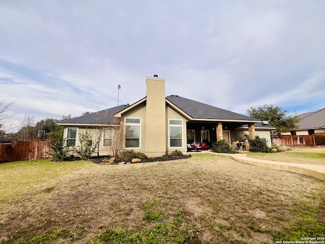 back of property featuring a lawn