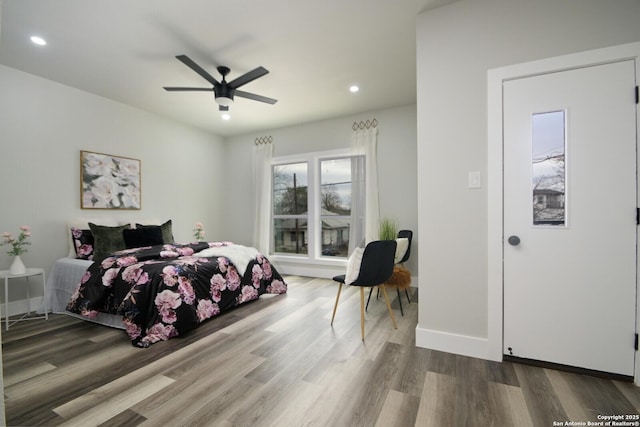 bedroom with recessed lighting, baseboards, wood finished floors, and ceiling fan