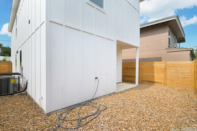 view of outdoor structure with fence private yard and central AC