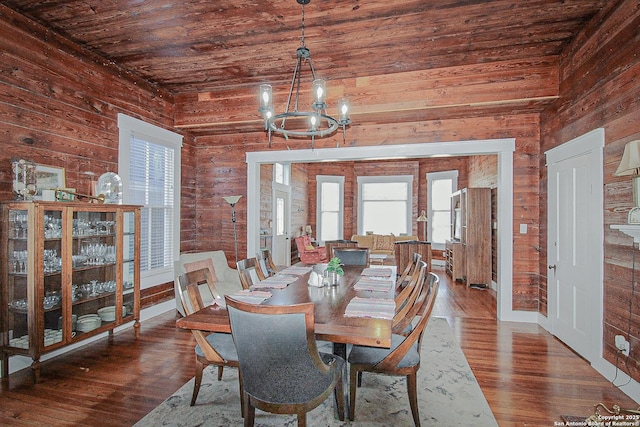 dining room featuring wooden ceiling, a chandelier, and hardwood / wood-style flooring