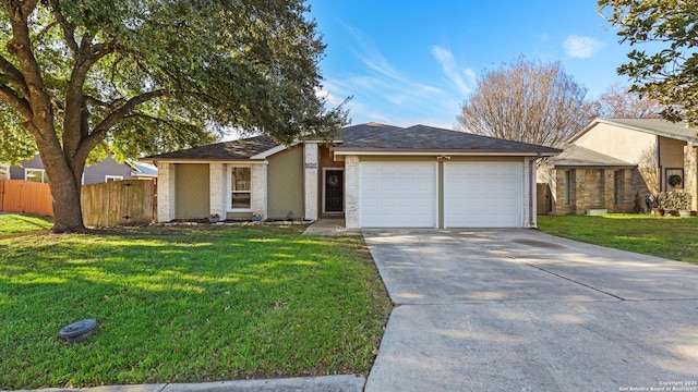 ranch-style house featuring a front lawn and a garage