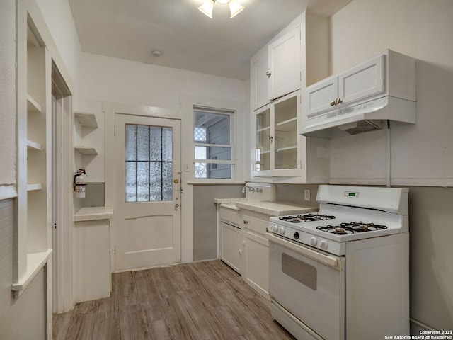 kitchen featuring gas range gas stove, light hardwood / wood-style floors, and white cabinets