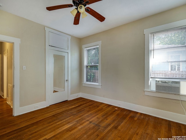 unfurnished bedroom with ceiling fan, cooling unit, and dark hardwood / wood-style floors