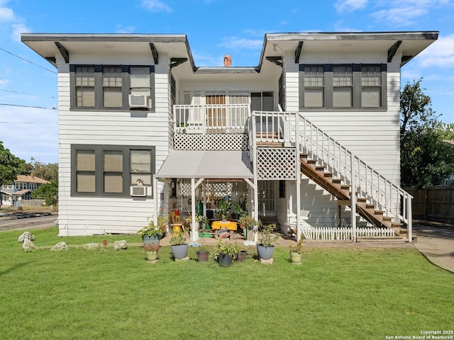 rear view of property featuring a lawn