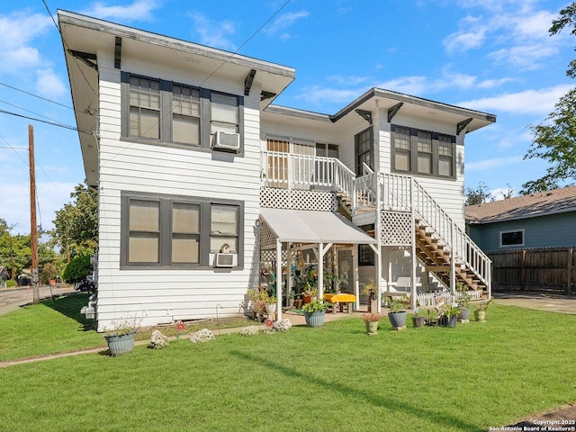 back of house featuring a lawn and cooling unit