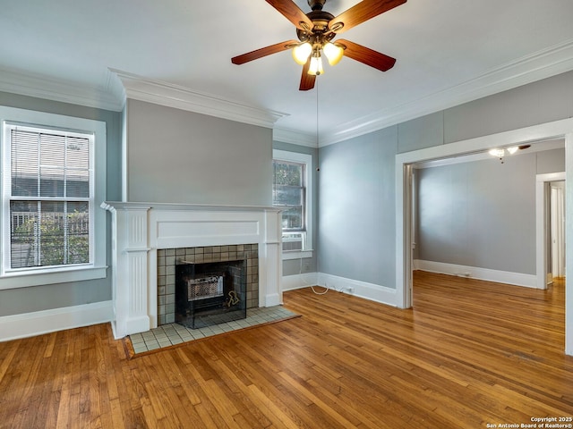 unfurnished living room featuring ceiling fan, wood-type flooring, and ornamental molding