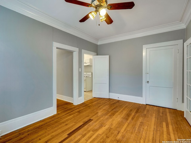 unfurnished bedroom with ceiling fan, crown molding, light hardwood / wood-style floors, and washer / clothes dryer