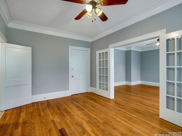 spare room with ceiling fan, french doors, and crown molding