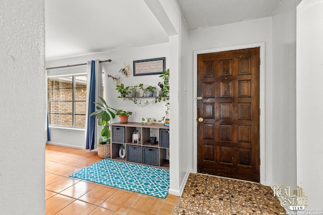 tiled entrance foyer with a textured ceiling