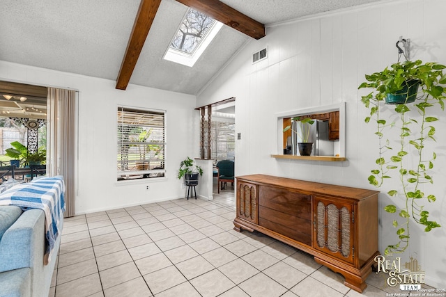 interior space with a textured ceiling and lofted ceiling with skylight