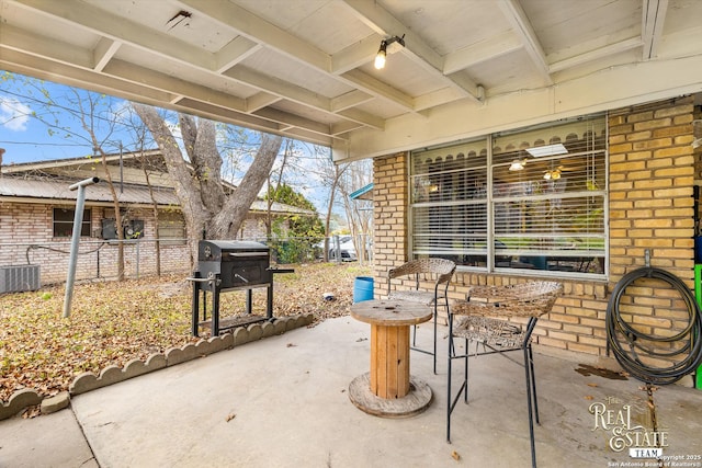 view of patio with cooling unit and a grill