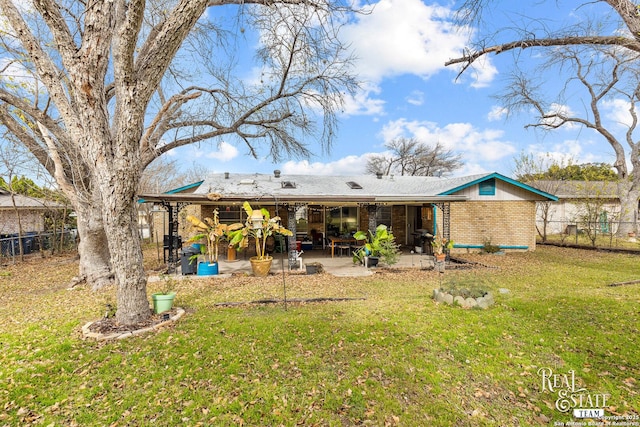 rear view of house with a yard and a patio