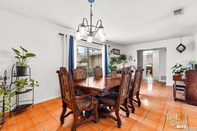 tiled dining space featuring a chandelier