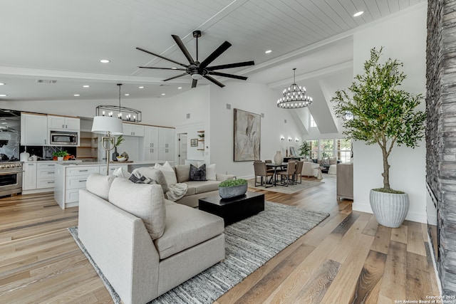 living room with ceiling fan, light hardwood / wood-style flooring, lofted ceiling with beams, and wooden ceiling