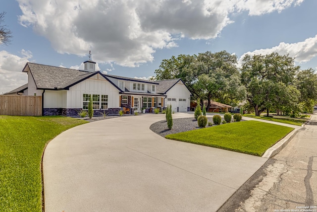 view of front of property featuring a garage and a front yard