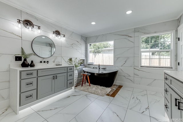 bathroom featuring a tub to relax in and vanity