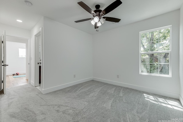 carpeted empty room with ceiling fan