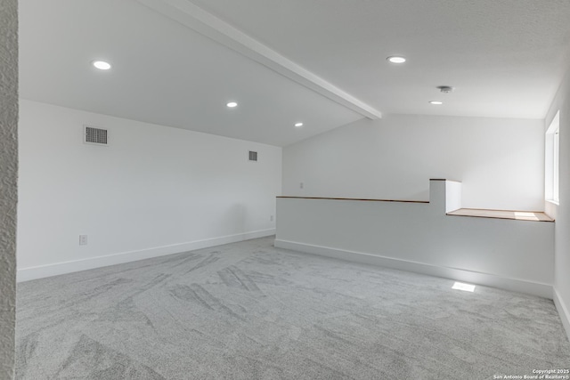 carpeted spare room with lofted ceiling with beams