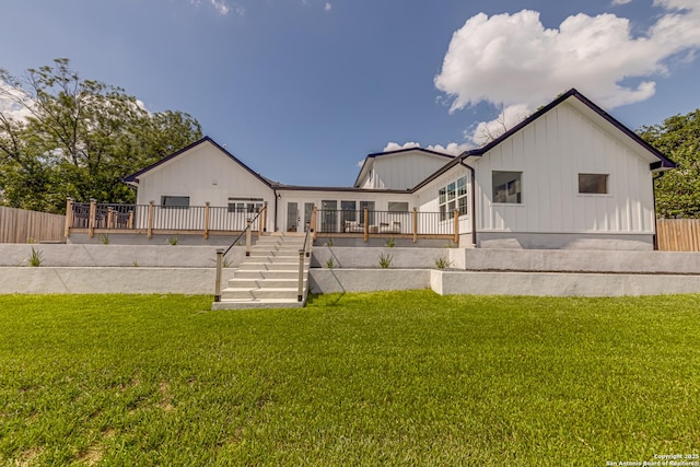 rear view of property featuring a yard