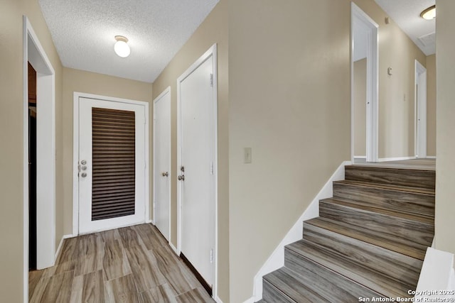 interior space featuring light hardwood / wood-style floors and a textured ceiling