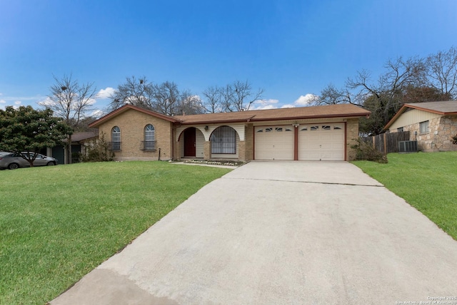 ranch-style home with a garage, a front yard, and cooling unit