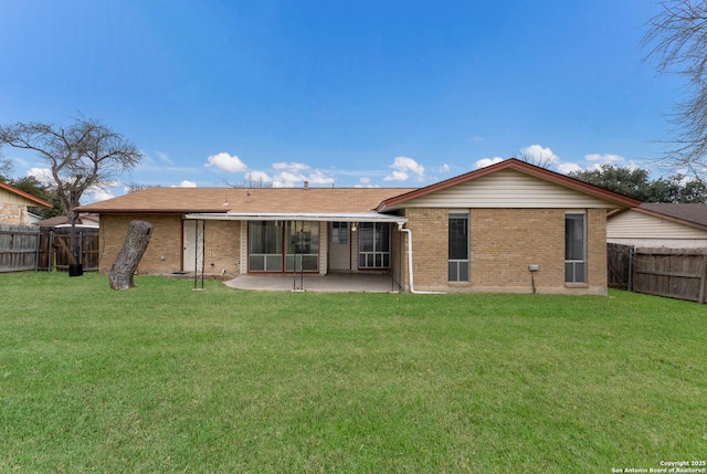 back of property featuring a patio area and a lawn