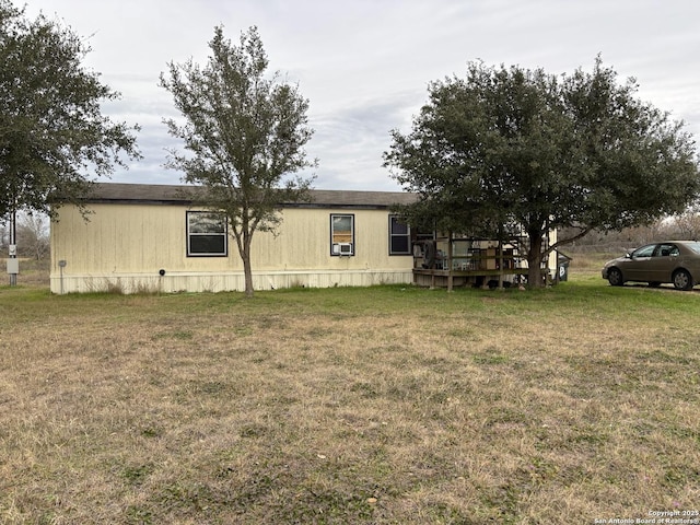 view of side of property featuring a yard