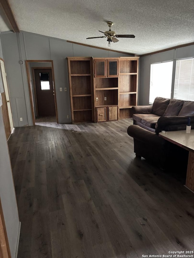 living room with vaulted ceiling, ornamental molding, wood-type flooring, and a textured ceiling