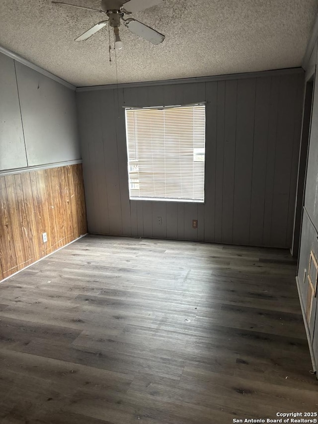 unfurnished room featuring ceiling fan, dark hardwood / wood-style floors, and a textured ceiling