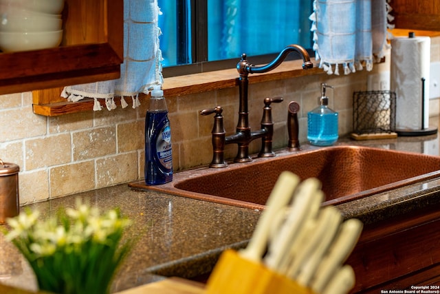 details featuring tasteful backsplash and a sink